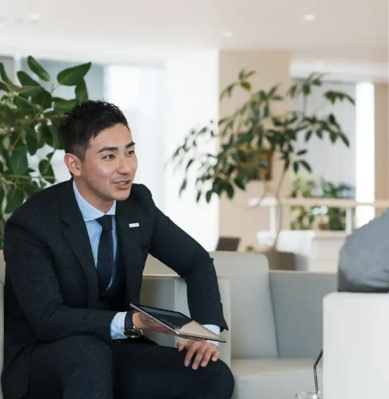 Sales rep at a car dealership holding an ipad